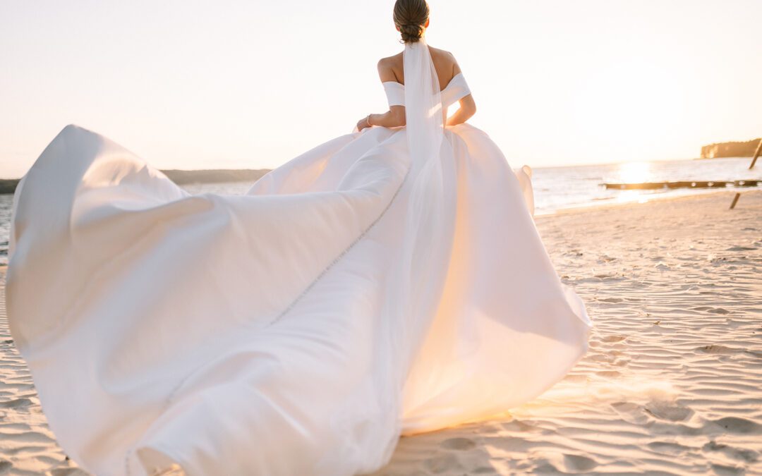 a bride running on a beach in her wedding dress